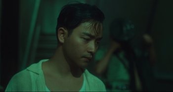 Movie still from “Days of Being Wild” (1990), directed by Kar-Wai Wong – A man with a beard is looking down at his face; Close Up shot, Low angle