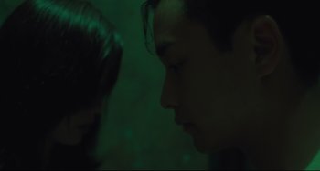 Movie still from “Days of Being Wild” (1990), directed by Kar-Wai Wong – A man and a woman looking into each other's eyes in the dark; Close Up shot, Over the shoulder angle