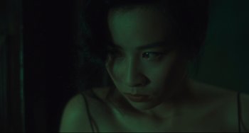Movie still from “Days of Being Wild” (1990), directed by Kar-Wai Wong – A young woman is looking into the camera; Close Up shot, High angle