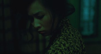 Movie still from “Days of Being Wild” (1990), directed by Kar-Wai Wong – A woman in a leopard print jacket looking sad; Close Up shot, High angle