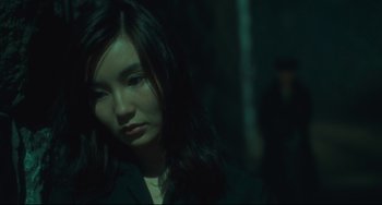 Movie still from “Days of Being Wild” (1990), directed by Kar-Wai Wong – A woman with long black hair is looking at the camera; Close Up shot, High angle