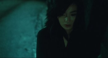 Movie still from “Days of Being Wild” (1990), directed by Kar-Wai Wong – A young woman with dark hair is standing in the dark; Close Up shot, High angle