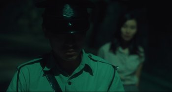 Movie still from “Days of Being Wild” (1990), directed by Kar-Wai Wong – A man in a police uniform and a woman in a green dress; Medium shot, Over the shoulder angle