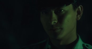 Movie still from “Days of Being Wild” (1990), directed by Kar-Wai Wong – A person wearing a hat in the dark; Extreme Close Up shot, Low angle
