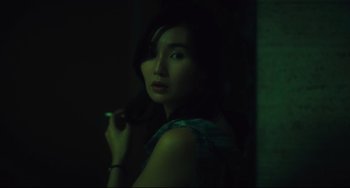 Movie still from “Days of Being Wild” (1990), directed by Kar-Wai Wong – A woman is holding a cigarette in her mouth; Close Up shot, High angle