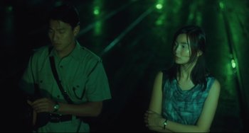 Movie still from “Days of Being Wild” (1990), directed by Kar-Wai Wong – A man and a woman standing next to each other in the dark; Medium shot, High angle