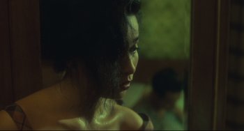 Movie still from “Days of Being Wild” (1990), directed by Kar-Wai Wong – A person's face in a dark room; Close Up shot, Over the shoulder angle