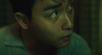 Movie still from “Days of Being Wild” (1990), directed by Kar-Wai Wong – A man's face with green eyes; Close Up shot, Low angle