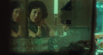 Movie still from “Days of Being Wild” (1990), directed by Kar-Wai Wong – A woman sitting in front of a bathroom mirror; Medium shot, Over the shoulder angle