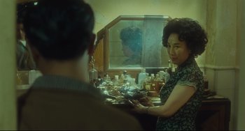 Movie still from “Days of Being Wild” (1990), directed by Kar-Wai Wong – A man and a woman in front of a bathroom mirror; Medium shot, Over the shoulder angle