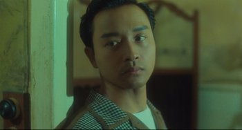 Movie still from “Days of Being Wild” (1990), directed by Kar-Wai Wong – A man with a nose ring looking at the camera; Close Up shot, Low angle