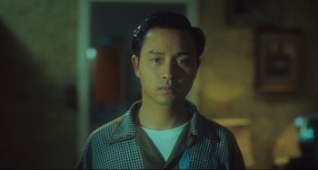 Movie still from “Days of Being Wild” (1990), directed by Kar-Wai Wong – A man in a plaid shirt is looking at the camera; Close Up shot, Low angle