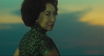 Movie still from “Days of Being Wild” (1990), directed by Kar-Wai Wong – A woman in a green dress is looking at the camera; Medium shot, Low angle