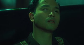 Movie still from “Days of Being Wild” (1990), directed by Kar-Wai Wong – A person wearing a black shirt; Close Up shot, Low angle