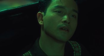 Movie still from “Days of Being Wild” (1990), directed by Kar-Wai Wong – A person wearing a black shirt; Close Up shot, High angle