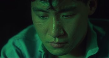 Movie still from “Days of Being Wild” (1990), directed by Kar-Wai Wong – A person's face in green light; Extreme Close Up shot, High angle