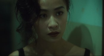 Movie still from “Days of Being Wild” (1990), directed by Kar-Wai Wong – A woman's face in a mirror; Close Up shot, High angle