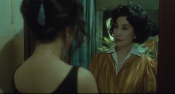 Movie still from “Days of Being Wild” (1990), directed by Kar-Wai Wong – Two women are looking at each other in a mirror; Medium shot, Over the shoulder angle