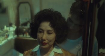 Movie still from “Days of Being Wild” (1990), directed by Kar-Wai Wong – A man is grooming an older woman's hair; Close Up shot, Over the shoulder angle