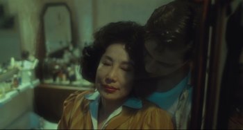 Movie still from “Days of Being Wild” (1990), directed by Kar-Wai Wong – A man and a woman embracing each other in a dimly - lit room; Close Up shot, Low angle
