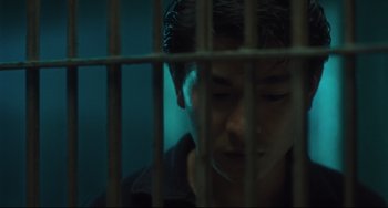 Movie still from “Days of Being Wild” (1990), directed by Kar-Wai Wong – A young man is looking through bars of a jail cell; Close Up shot, Low angle