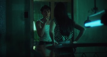 Movie still from “Days of Being Wild” (1990), directed by Kar-Wai Wong – A man and a woman are looking at each other in the mirror; Medium shot, Over the shoulder angle