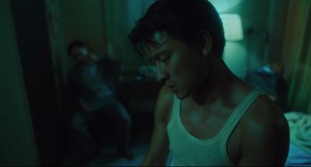 Movie still from “Days of Being Wild” (1990), directed by Kar-Wai Wong – A man sitting in a dark room with his eyes closed; Close Up shot, Low angle