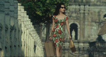 Movie still from “Days of Being Wild” (1990), directed by Kar-Wai Wong – A woman walking down the street holding a suitcase; Medium shot, Low angle
