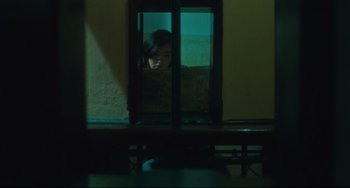 Movie still from “Days of Being Wild” (1990), directed by Kar-Wai Wong – A woman looking out of a window at night; Medium shot, High angle