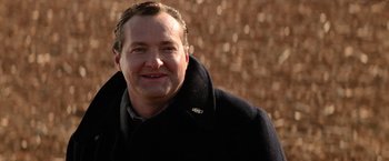 Movie still from “Days of Thunder” (1990), directed by Tony Scott – A person wearing a jacket; Close Up shot, Over the shoulder angle