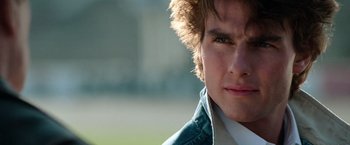 Movie still from “Days of Thunder” (1990), directed by Tony Scott – A young man's face in a field; Close Up shot, Over the shoulder angle