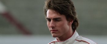 Movie still from “Days of Thunder” (1990), directed by Tony Scott – A person wearing a racing suit; Close Up shot, Low angle