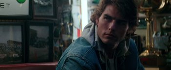 Movie still from “Days of Thunder” (1990), directed by Tony Scott – A person wearing a jean jacket; Close Up shot, Over the shoulder angle