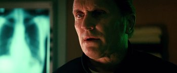 Movie still from “Days of Thunder” (1990), directed by Tony Scott – A person looking at the camera; Close Up shot, Low angle