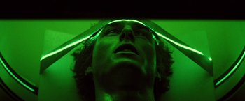 Movie still from “Days of Thunder” (1990), directed by Tony Scott – A man with green light on his head and face; Close Up shot, Overhead angle