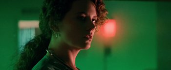 Movie still from “Days of Thunder” (1990), directed by Tony Scott – A woman's face in front of a red light; Close Up shot, Low angle