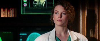 Movie still from “Days of Thunder” (1990), directed by Tony Scott – A woman with curly hair wearing a white lab coat; Close Up shot, Low angle