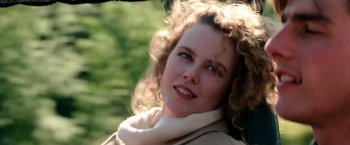 Movie still from “Days of Thunder” (1990), directed by Tony Scott – A person with curly hair wearing a jacket; Close Up shot, Low angle