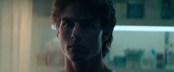 Movie still from “Days of Thunder” (1990), directed by Tony Scott – A person wearing a white t - shirt; Close Up shot, Over the shoulder angle