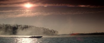 Movie still from “Days of Thunder” (1990), directed by Tony Scott – A boat in a body of water near a body of water; Extreme Wide shot, Low angle