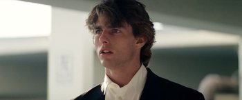 Movie still from “Days of Thunder” (1990), directed by Tony Scott – A person wearing a suit and tie; Close Up shot, Low angle