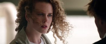 Movie still from “Days of Thunder” (1990), directed by Tony Scott – A person with curly hair; Close Up shot, Low angle