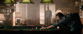Movie still from “Days of Thunder” (1990), directed by Tony Scott – A man and a woman standing in front of a pool table; Wide shot, Over the shoulder angle