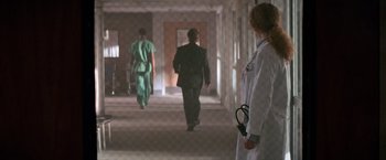 Movie still from “Days of Thunder” (1990), directed by Tony Scott – A group of doctors walking down a hall way; Wide shot, Low angle