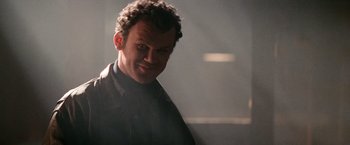 Movie still from “Days of Thunder” (1990), directed by Tony Scott – A person wearing a black shirt; Close Up shot, Low angle