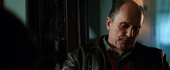 Movie still from “Days of Thunder” (1990), directed by Tony Scott – A person wearing a leather jacket; Close Up shot, Low angle