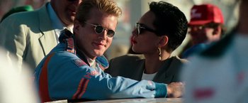 Movie still from “Days of Thunder” (1990), directed by Tony Scott – A man and a woman sitting next to each other; Close Up shot, Low angle