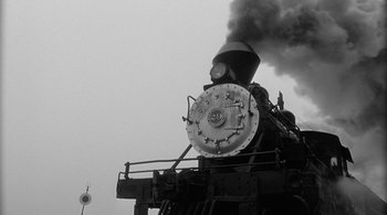 Movie still from “Dead Man” (1995), directed by Jim Jarmusch – An old steam train is blowing out the smoke; Extreme Wide shot, Low angle