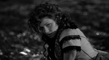 Movie still from “Dead Man” (1995), directed by Jim Jarmusch – A black and white photo of a woman with curly hair; Close Up shot, High angle