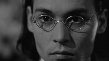 Movie still from “Dead Man” (1995), directed by Jim Jarmusch – A person wearing glasses; Close Up shot, Low angle